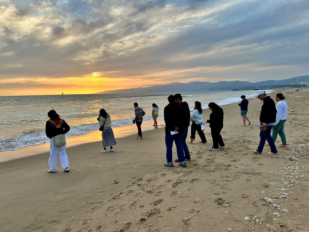 Group walking along the beach at sunset at Maaleh Hayim