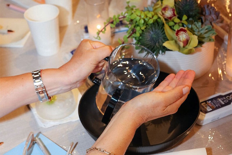Water poured from a pitcher over hands during a ritual at Maaleh Hayim